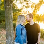Couple with noses touching near tree in the fall
