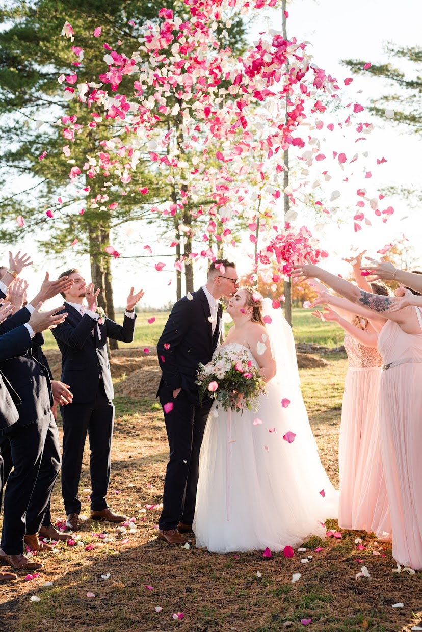Rose Petals thrown in air over couple on wedding day
