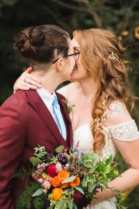 Two women sharing a kiss on their wedding day