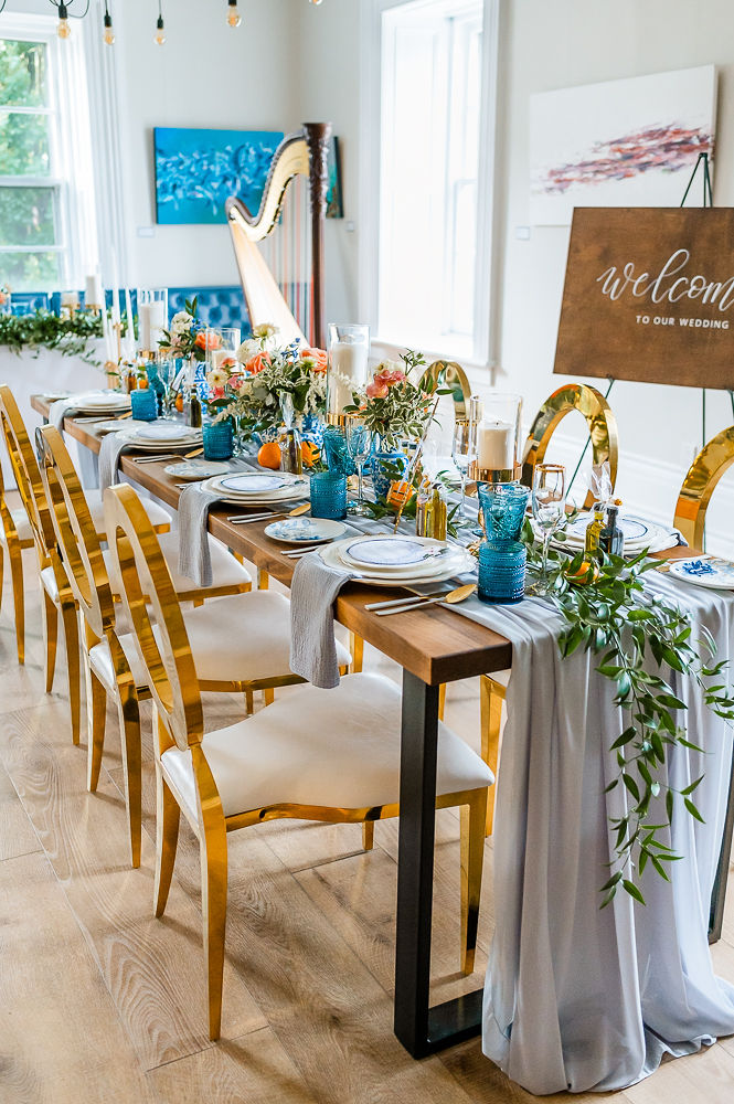 Wedding table set up with gold chairs and harvest table